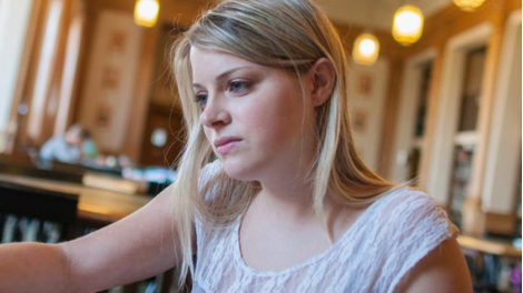 A StFX business student studying in the library