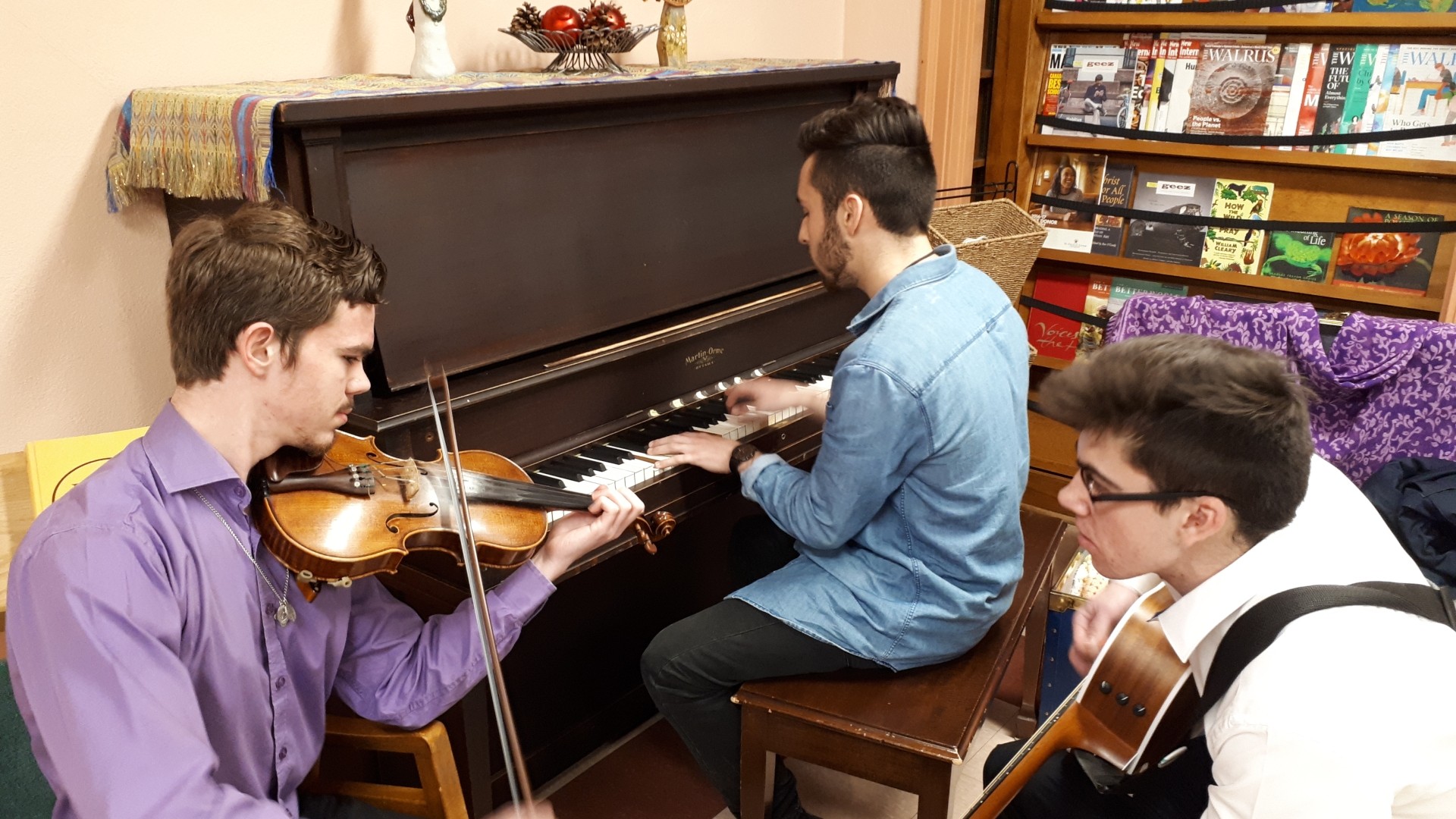 People playing violin, piano and guitar