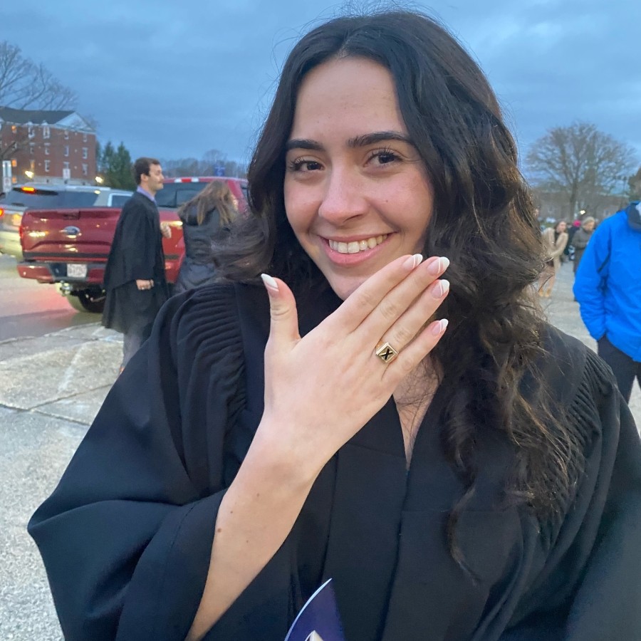 Student showing their x ring after the ceremony  