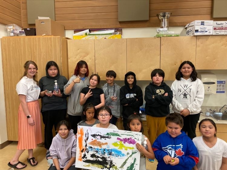 Outreach class holding up a poster