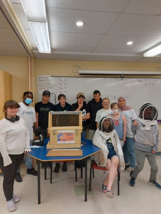 Group Picture of Students at the Lab Around an Apiary
