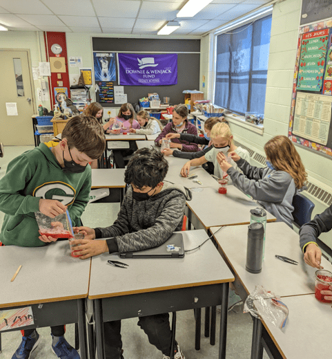 Students at the Chemistry Lab Preparing Red Substance Using Beakers