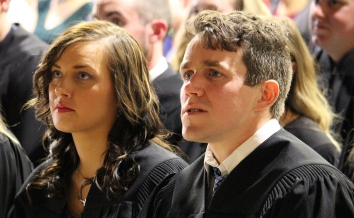 A couple of people that are sited aside listening a conference