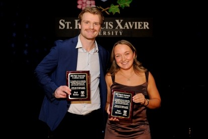Mark Woolley and Anna MacCara receiving the 2025 Community X-Cellence Award
